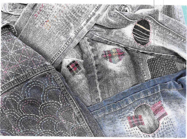 Picture of clever stitching and colorful patches on denim fabric